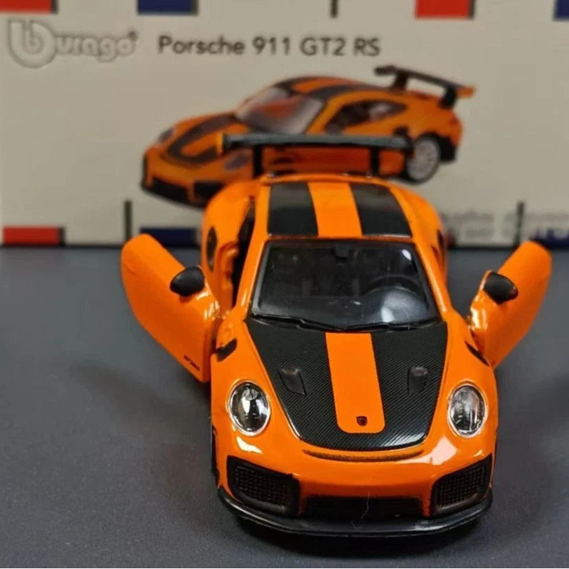 Orange and black model car in front of a Porsche 911 GT2 RS box
